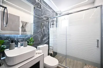 a bathroom with a sink and a toilet and a shower at Sea & Joy Studio in Ialyssos