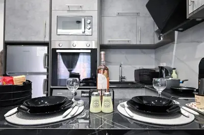 a kitchen with a table with plates and wine glasses at Sea & Joy Studio in Ialyssos