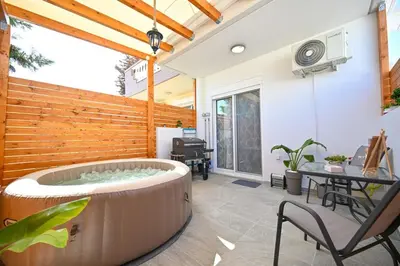 a hot tub in the middle of a patio at Sea & Joy Studio in Ialyssos