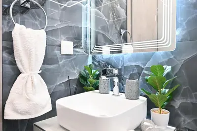 a bathroom with a sink and a mirror at Sea & Joy Studio in Ialyssos