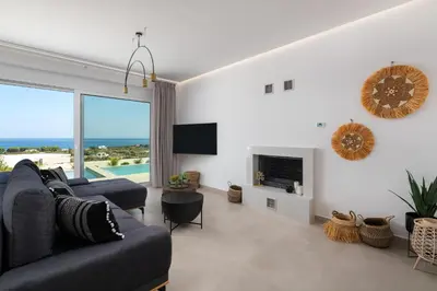 a living room with a couch and a fireplace at Luxurious Villa with sea views in Gennadi Rhodes in Gennadi