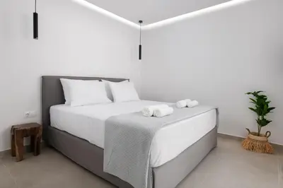 a white bedroom with a bed with towels on it at Luxurious Villa with sea views in Gennadi Rhodes in Gennadi