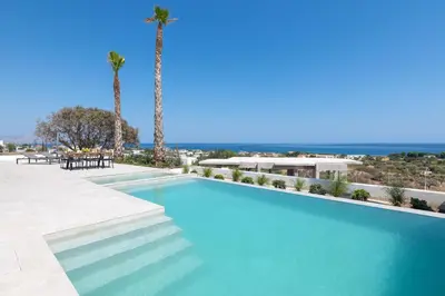 a swimming pool with palm trees in the background at Luxurious Villa with sea views in Gennadi Rhodes in Gennadi