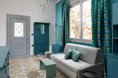 a living room with a couch and a window at Plumeria House in Rhodes Town