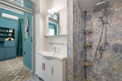 a bathroom with a sink and a shower at Plumeria House in Rhodes Town
