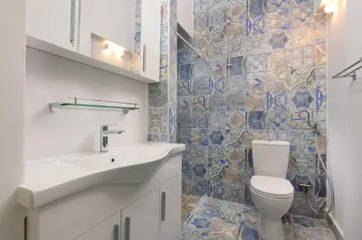a bathroom with a sink and a toilet at Plumeria House in Rhodes Town