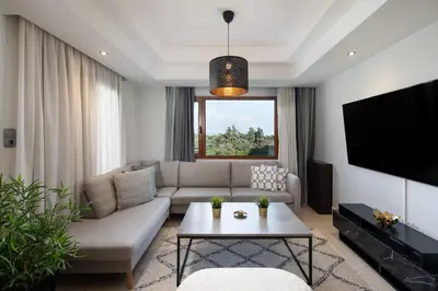 a living room with a couch and a tv at Dora 3 bedroom apartment in Rhodes Town