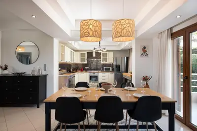 a dining room and kitchen with a table and chairs at Dora 3 bedroom apartment in Rhodes Town