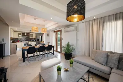 a living room with a couch and a table at Dora 3 bedroom apartment in Rhodes Town