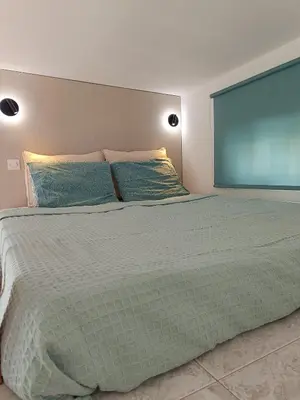 a bedroom with a large bed with a large window at Serene Ocean Haraki in Haraki