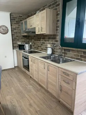 a kitchen with wooden cabinets and a sink at Villa Oasis 3 in Kalithies