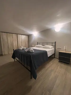 a bedroom with a bed and a wooden floor at Villa Oasis 3 in Kalithies