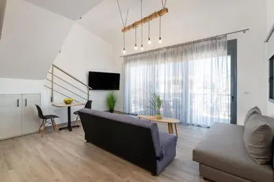 a living room with a couch and a table at Stone Apartments in Kremasti