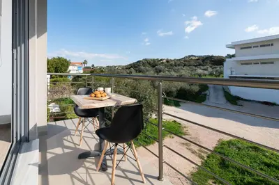 a balcony with a table with fruit on it at Stone Apartments in Kremasti
