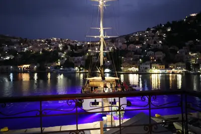 a boat is docked in a harbor at night at 