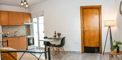 a kitchen with a table and chairs in a room at Casa 30 House Complex Center of Ialysos in Ialyssos