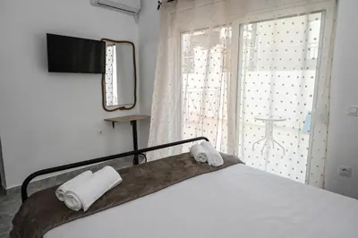 a bedroom with a bed with two towels on it at Casa 30 House Complex Center of Ialysos in Ialyssos