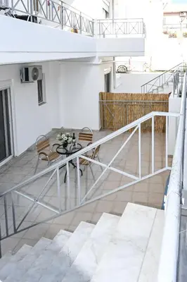 a balcony with a table and chairs on a building at Casa 30 House Complex Center of Ialysos in Ialyssos