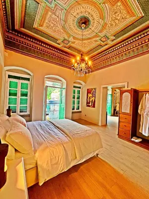 a bedroom with a large bed with a ceiling at 