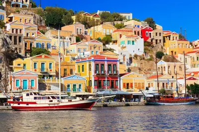 a group of colorful houses and a boat in the water at 