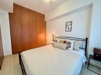 a bedroom with a bed and a wooden cabinet at Papas house 2 near Faliraki kalithies in Kalithies