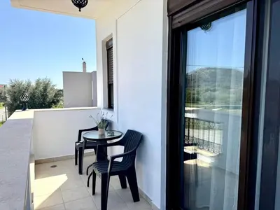 a patio with a table and chairs on a balcony at Papas house 2 near Faliraki kalithies in Kalithies