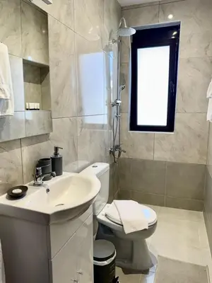 a bathroom with a sink and a toilet and a window at Papas house 2 near Faliraki kalithies in Kalithies