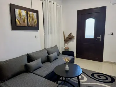 a living room with a couch and a table and a door at Papas house 2 near Faliraki kalithies in Kalithies
