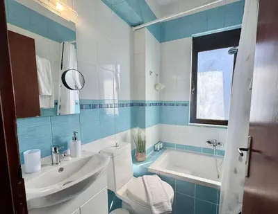 a bathroom with a toilet and a sink and a tub at Papas House 3 near Faliraki Kalithies in Kalithies