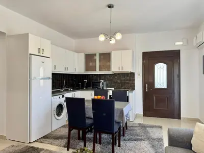 a kitchen with a table and chairs and a refrigerator at Papas House 3 near Faliraki Kalithies in Kalithies