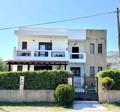 a large white house with a fence in front of it at Papas House 3 near Faliraki Kalithies in Kalithies