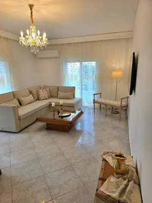 a living room with a couch and a table at City Center Luxury Spacious apt A&M II in Rhodes Town