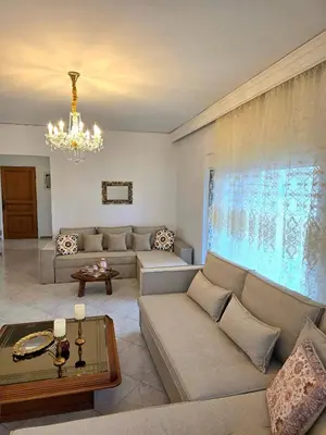 a living room with a couch and a chandelier at City Center Luxury Spacious apt A&M II in Rhodes Town