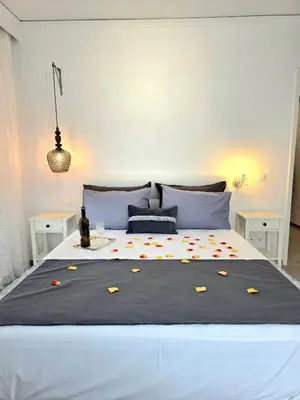 a bedroom with a large bed with flowers on it at City Center Luxury Spacious apt A&M II in Rhodes Town