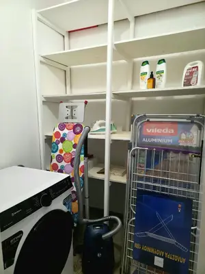 a kitchen with a refrigerator and a shelf with milk at City Center Luxury Spacious apt A&M II in Rhodes Town