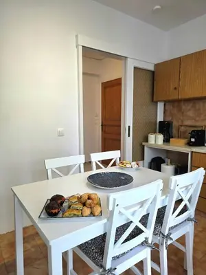 a white table with a plate of food on it at City Center Luxury Spacious apt A&M II in Rhodes Town