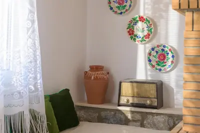 a room with plates and a radio on a shelf at Billys House in Lardos