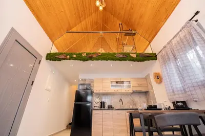 a kitchen with a dining table and a ceiling at Hera Elysium Retreat Villas in Kalavárda