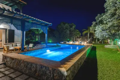 a swimming pool in a backyard at night at Mi Casa South Rhodes in Lachania