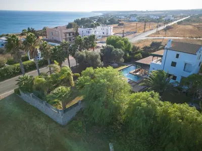 an aerial view of a resort with a pool and trees at Mi Casa South Rhodes in Lachania