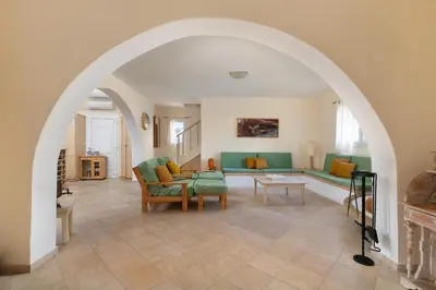 an archway in a living room with a couch and chairs at Mi Casa South Rhodes in Lachania