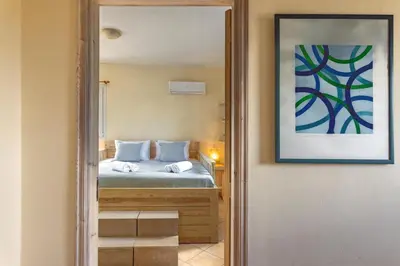 a bedroom with a bed and a picture on the wall at Mi Casa South Rhodes in Lachania