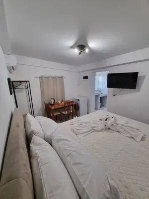 a living room with a large bed and a couch at The Garden House in Paradisi in Paradeísion