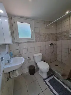 a bathroom with a toilet and a sink at The Garden House in Paradisi in Paradeísion