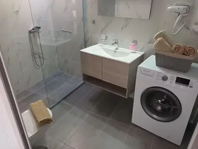 a bathroom with a washing machine and a sink at The Sun House in Paradisi in Rhodes Town