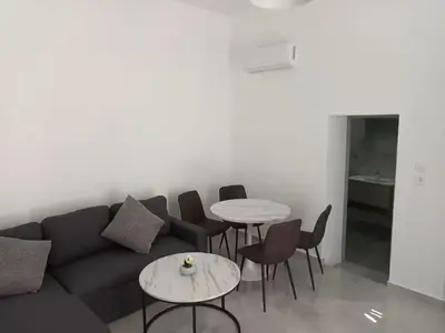a living room with a couch and chairs and tables at The Sun House in Paradisi in Rhodes Town