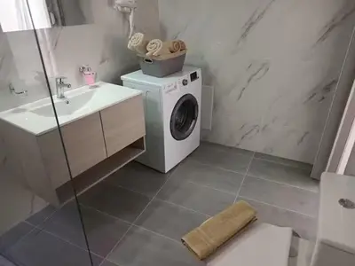a bathroom with a washing machine and a sink at The Sun House in Paradisi in Rhodes Town
