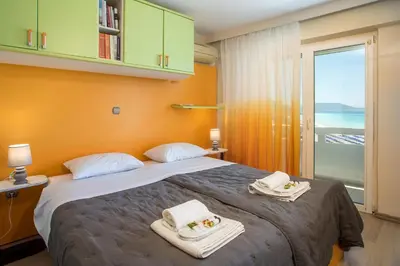 a bedroom with a large bed with towels on it at Molos Seaside Apartment in Rhodes Town
