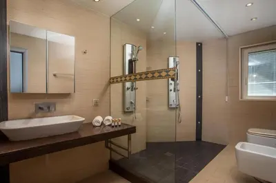 a bathroom with a sink and a toilet and a shower at Molos Seaside Apartment in Rhodes Town