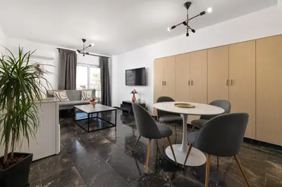 a kitchen and living room with a table and chairs at Elli City Apartment in Rhodes Town